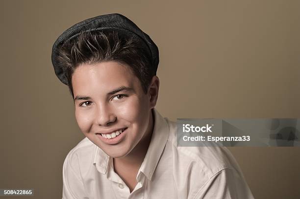 Laughing Boy With A Cap On A Brown Background Stock Photo - Download Image Now - 12-13 Years, 14-15 Years, Adolescence