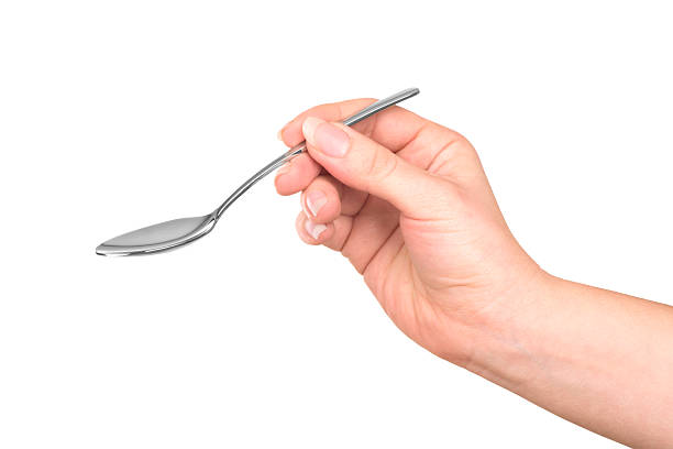 istock hand holding a stainless-steel spoon 508423422