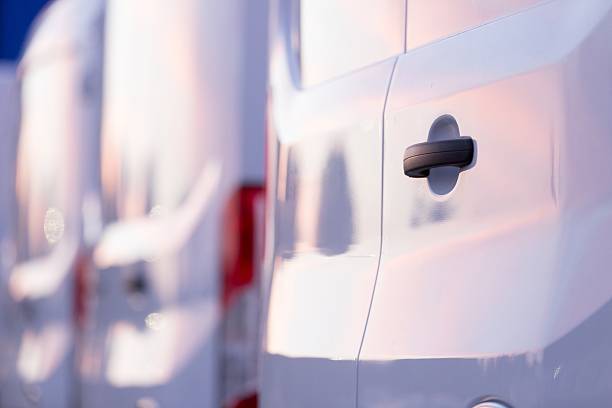 istock White vans rear view on parking lot 508424301