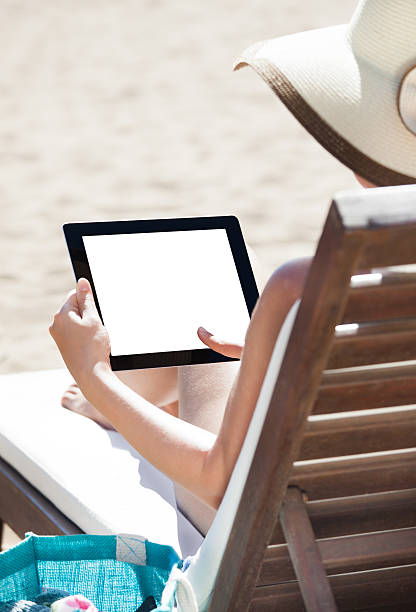 istock Woman Using Digital Tablet On Beach Chair 508424455