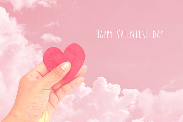 istock Female hand giving red heart on sky background 508424658