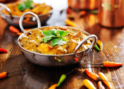 indian saag paneer curry in balti dish with cilantro garnish