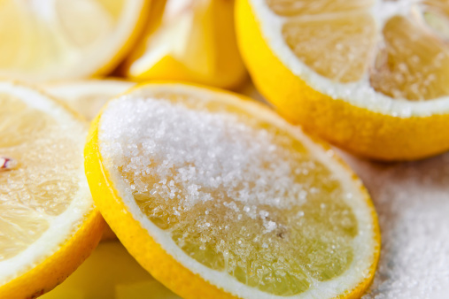 Fresh lemon with sugar on a white plate