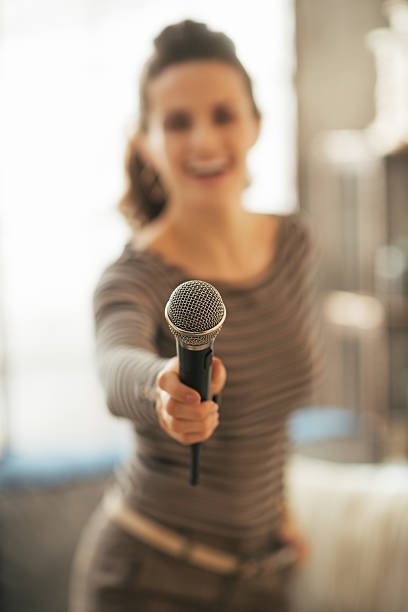 istock closeup on young woman stretching microphone in camera 508427451