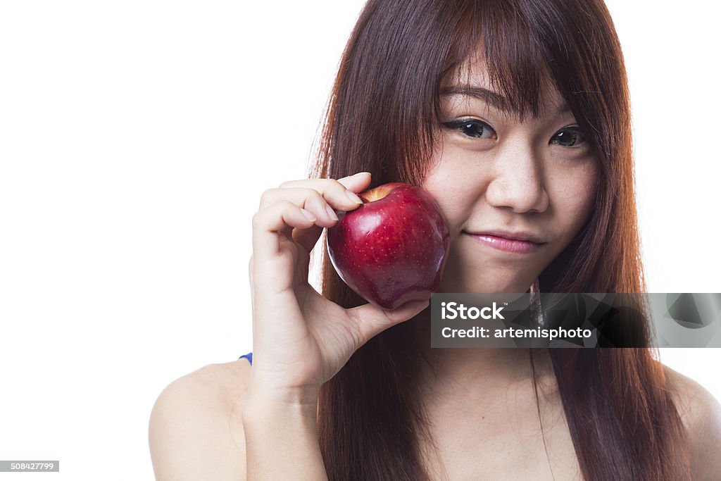 Healthy Eating Young woman holding an apple against white background Adult Stock Photo