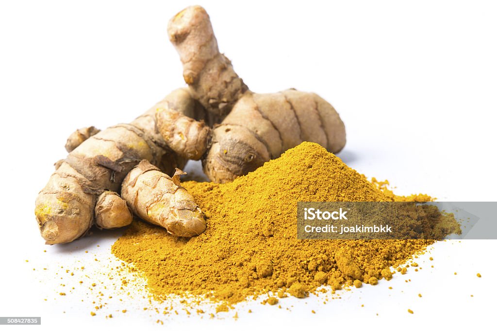 Fresh turmeric isolated on white Close up view of fresh turmeric powdered heap with some turmeric plant, elements isolated on white. Turmeric Stock Photo