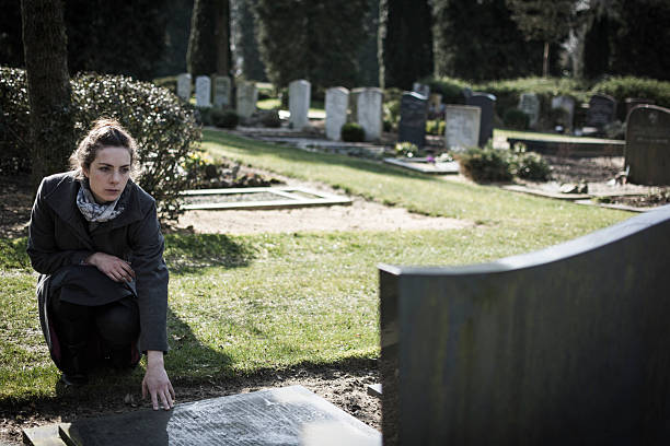 istock Woman sitting at grave 508427879