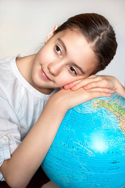 istock Dreaming about holidays. Thoughtful girl with blue round globe 508428105