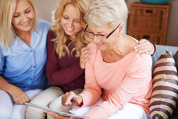 istock Girl with mom supporting grandma which learning use digital tablet 508440243