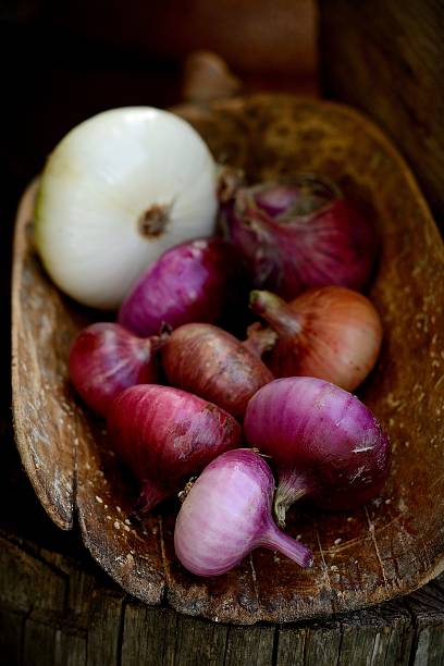 istock Fresh red onions on a wooden background 508440665