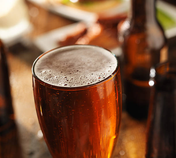istock beer glass at meal table with foam 508441195