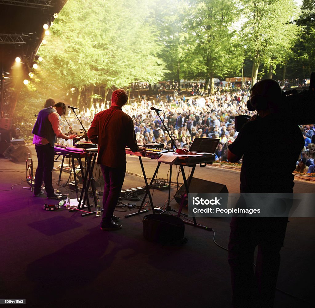 Festival highlight! Rearview shot of a band on stage at an outdoor music festival Outdoors Stock Photo