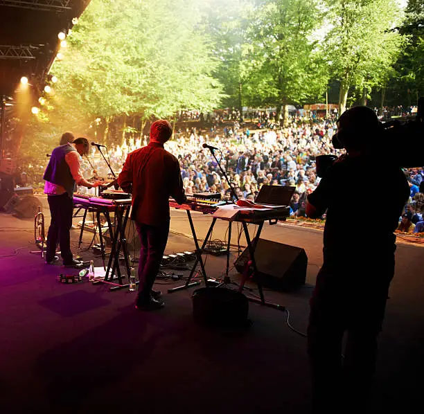 Rearview shot of a band on stage at an outdoor music festival