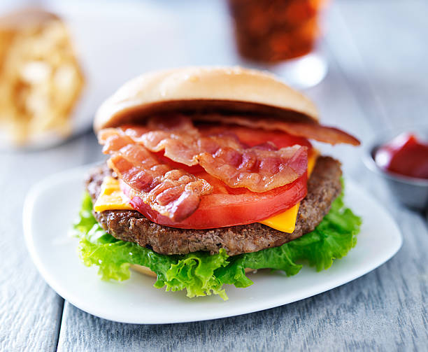 bacon chesseburger with fries and cola bacon chesseburger with fries and cola with bun off to the side bacon cheeseburger stock pictures, royalty-free photos & images