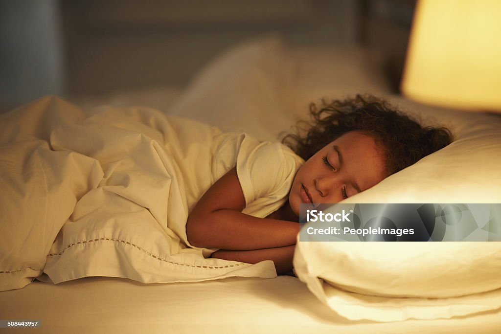 I like mom's bed the best A cute little girl fast asleep in a double bed Sleeping Stock Photo