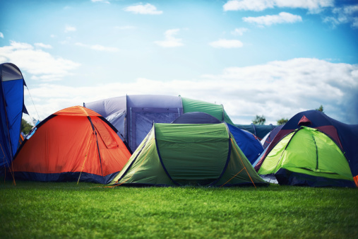 Tourist camping tent in the lawn green grass