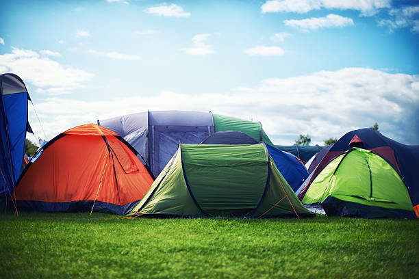 The great getaway A large group of tents pitched together outdoors music festival camping summer vacations stock pictures, royalty-free photos & images
