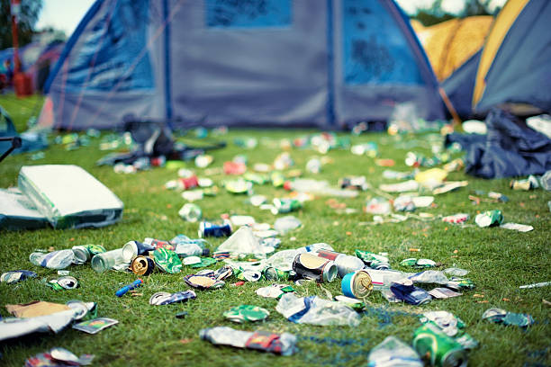 The after-effects of a good time Shot of a campsite filled with litter music festival camping summer vacations stock pictures, royalty-free photos & images