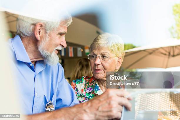 Senior Couple Looking Something On Digital Tablet Stock Photo - Download Image Now - 70-79 Years, 80-89 Years, Active Seniors