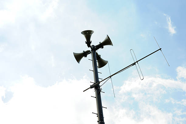 istock Loudspeakers with antenna against blue sky 508445931