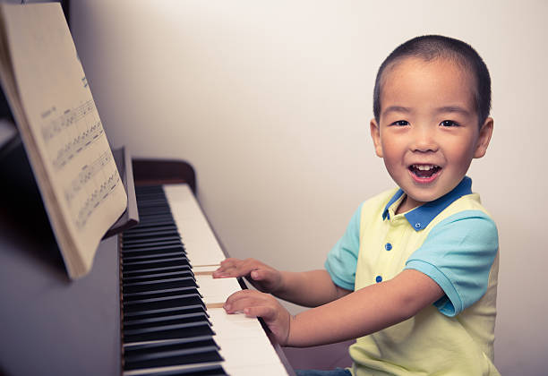 istock Little boys playing the piano 508446095