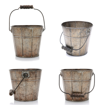 Collage of four views of an old fashioned metal bucket. Isolated on white with slight reflections.