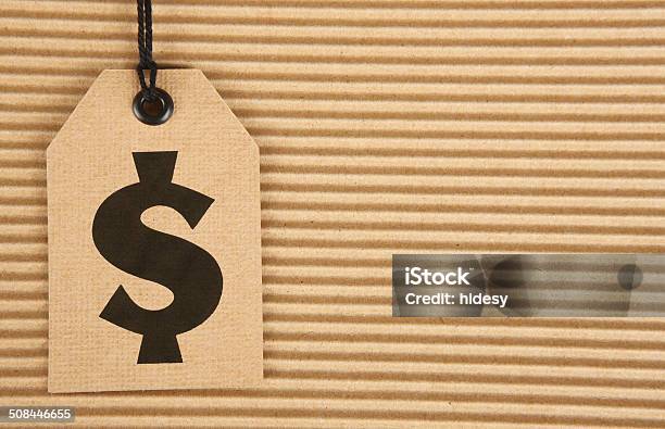 Dollar Sign On Cardboard Tag On Corrugated Cardboard Stock Photo - Download Image Now