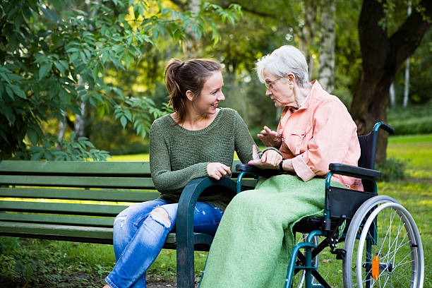 istock charming young and senior woman have a talk in park 508447501