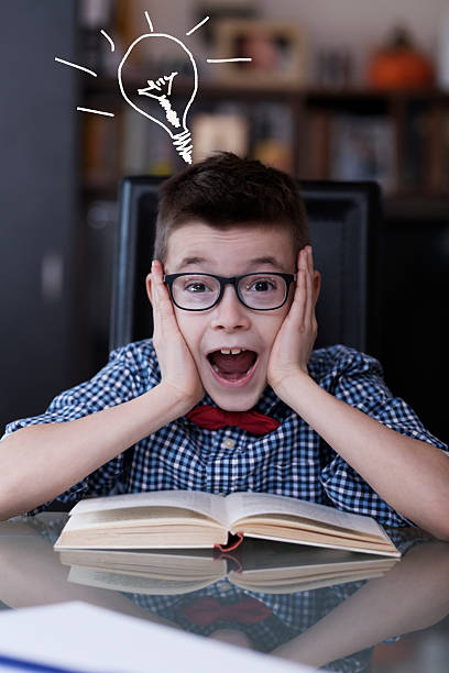 istock Cute boy reading book and screaming 508450016