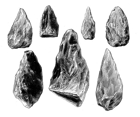 Antique illustration of prehistoric flint weapons (evidence from Saint-Acheul, France): bifacial handaxes made from chert cobbles