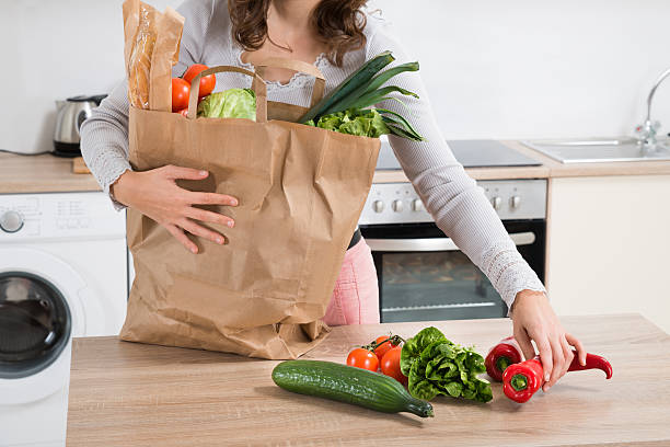 istock Woman Holding Grocery Bag 508452664