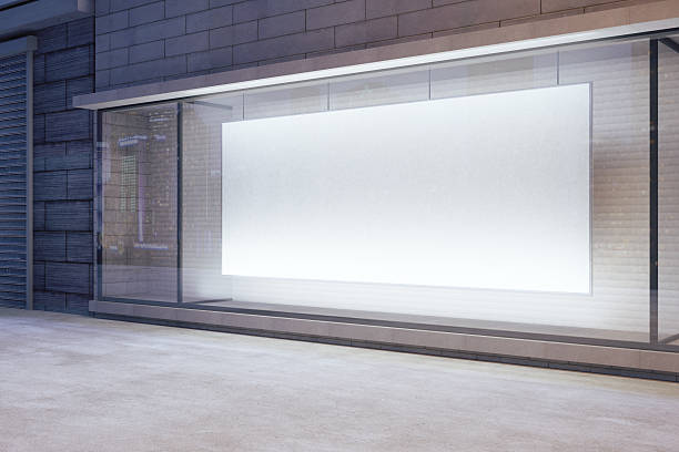 istock Large blank banner in a shop window at night 508452984