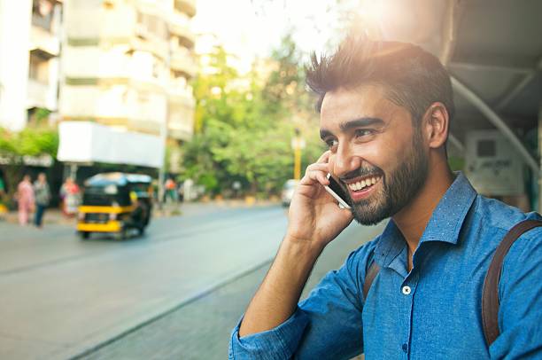 istock Handsome smiling man talking on mobile phone 508454080