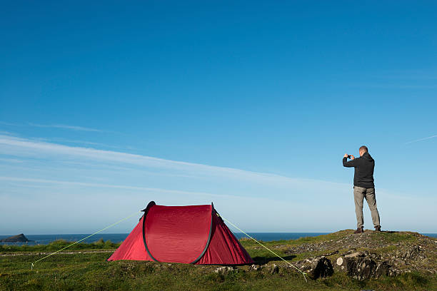 istock Man taking photo with mobile phone on the Cornish Coast 508454470