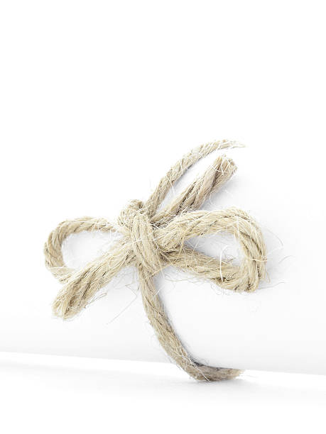 istock Handmade natural rope knot tied on white paper roll isolated 508454738