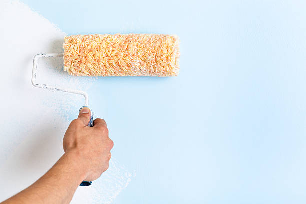 istock Close up of painter arm painting a wall 508455124