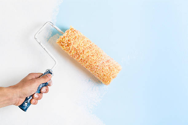 istock Close up of painter hand painting a wall 508455472