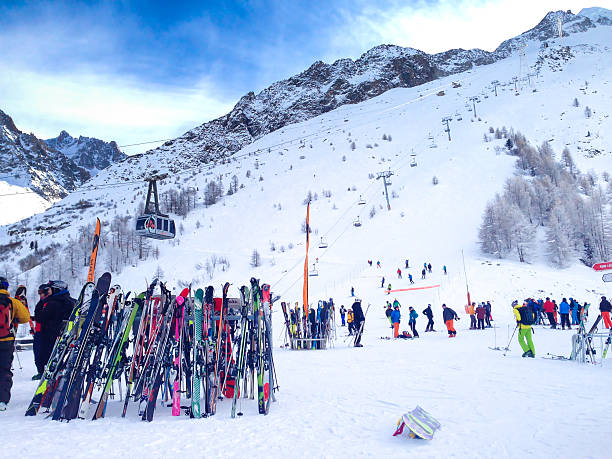 Chamonix, France - January , 24, 2015: People skiing, pile of Skis and slopes view at Les Grands Montets ski area near Chamonix, France