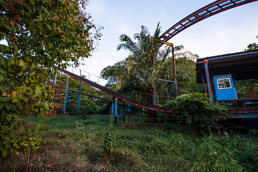 Rusty decayed roller coaster tracks at Yangon abandoned amusement park