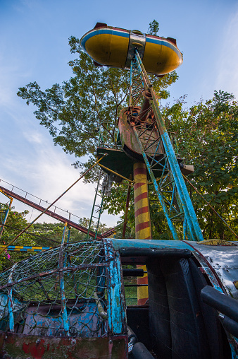 Rusty disused dive bomber fair ground ride at Yangon abandoned amusement park