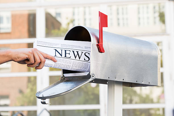 istock Person Hands Opening Mailbox To Remove Newspaper 508460296
