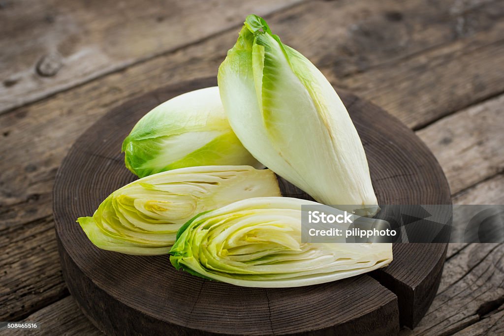 Fresh witloof on the wooden table  Fresh witloof on the wooden table  Endive Stock Photo