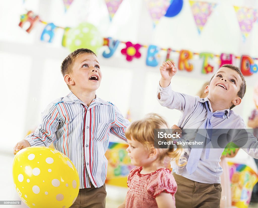Playful children on a birthday party. Little boys having fun on a birthday party.   Birthday Stock Photo
