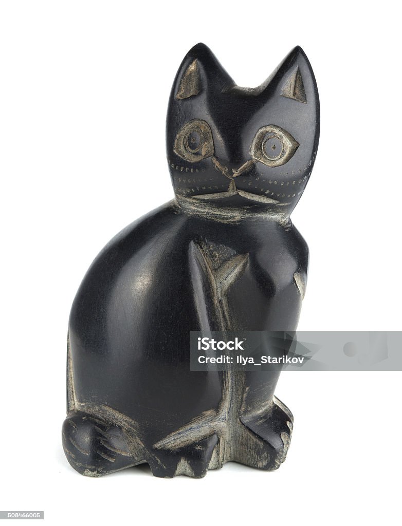 Statue cat Obsidian statue cat isolated on a white background Ancient Stock Photo