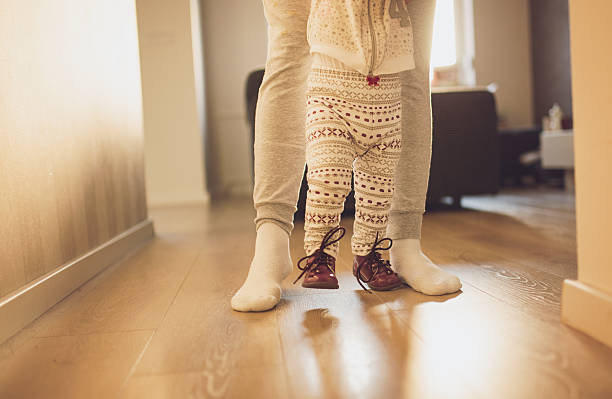 istock Mother helping cheerful baby learn to walk 508466416