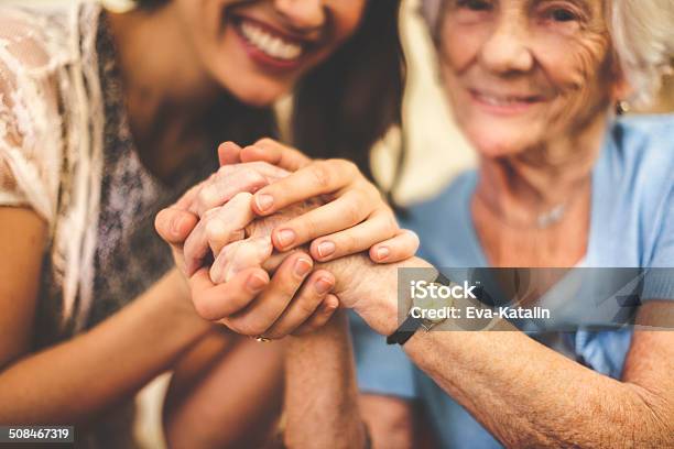 Closeup Of A Smiling Nurse Holding A Senior Womans Hand Stock Photo - Download Image Now