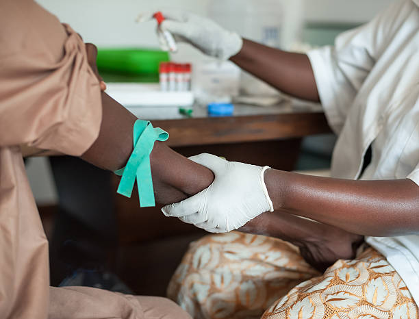 African nurse is drawing blood African nurse is drawing blood from african to perform a test aids stock pictures, royalty-free photos & images