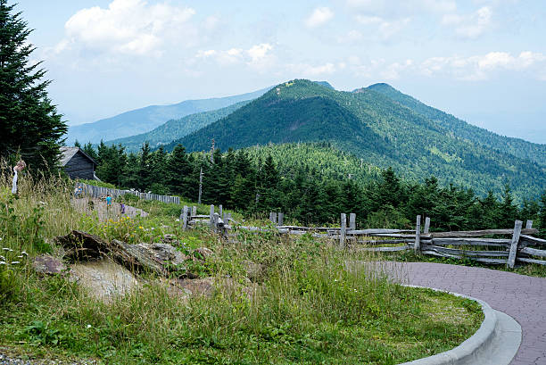 Mt. Mitchell in North Carolina Marion, North Carolina, USA. August 3, 2014. People walking up a paved walkway at Mt. Mitchell in North Carolina with Appalachian mountain peaks in the background. This is the highest mountain east of the Mississippi River. mt mitchell stock pictures, royalty-free photos & images
