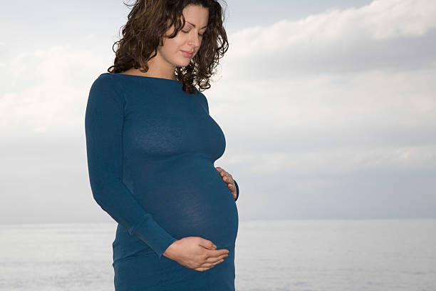 femme enceinte debout sur l'océan - herne bay photos et images de collection