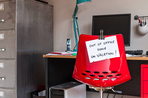 Out of Office. Gone on Vacation! Employee leaves note on back of office chair: "Out of Office. Gone on Vacation!" after work stock pictures, royalty-free photos & images